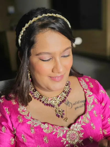 A close-up of Shreya's wedding makeup. The soft pink eyeshadow and glossy lips give her a youthful and romantic glow.