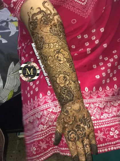 A full bridal arm design showcasing a variety of techniques, from detailed peacock motifs to delicate floral netting. I work patiently to ensure every element is perfect.