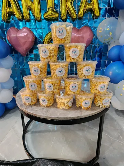 Our popcorn tubs displayed as part of the birthday decor. They are a great addition to any dessert table or favor station.