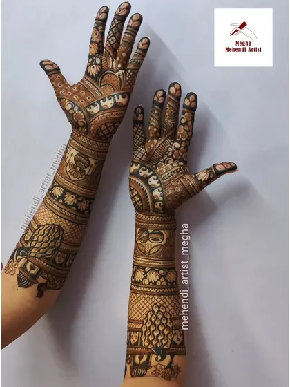 A full bridal design featuring peacocks on the back of the arms and elephants on the front. The hands tell a story with every intricate pattern.