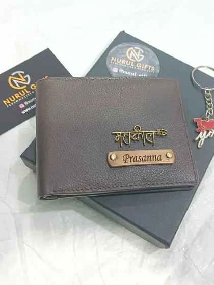 A personalized genuine leather wallet in a textured brown finish, featuring a 'Mahakal' charm and a nameplate, shown with a complimentary 'I love you' keychain.