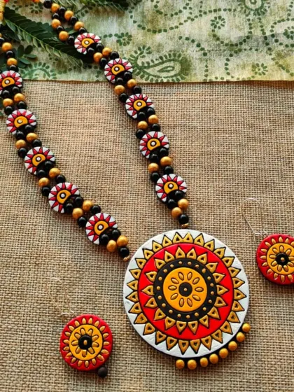 The same 'haram' style necklace with a red and white mandala pendant.