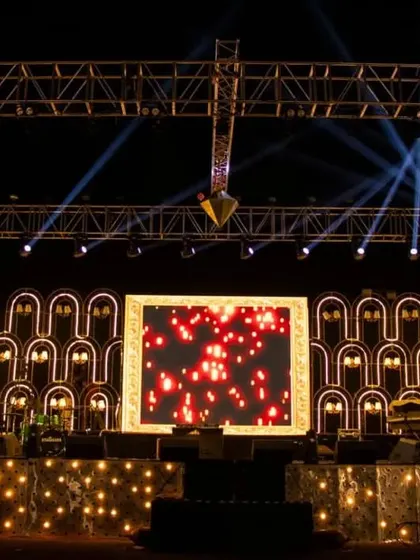 This image shows the versatility of the sangeet stage design. The combination of structural elements, truss lighting, and a central LED screen allows for a wide range of visual effects, from soft and romantic to bright and energetic.