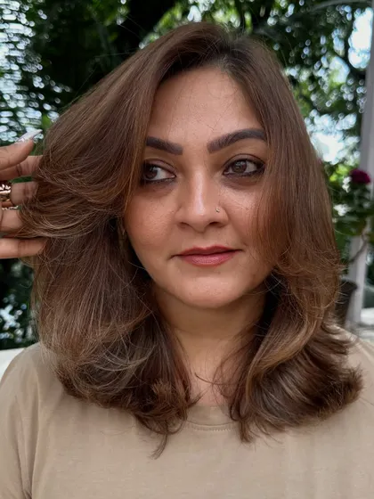 A close-up of a layered cut on medium-length hair. This style is perfect for adding volume and shape, making the hair look fuller and more dynamic.