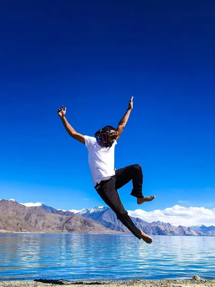 A joyful jump by the lake, expressing a feeling of freedom and energy.