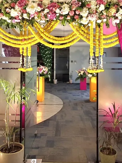The entrance to one of the office sections, framed with marigold garlands and bright pink drapes. This created a grand and festive feel for the company's Diwali party.