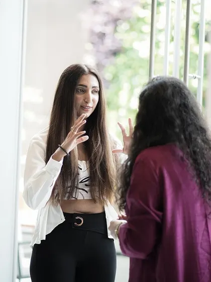 Engaging in a conversation with a guest during the Mother's Day brunch. These interactions are what make live events so special, allowing me to share my process and passion for art directly.