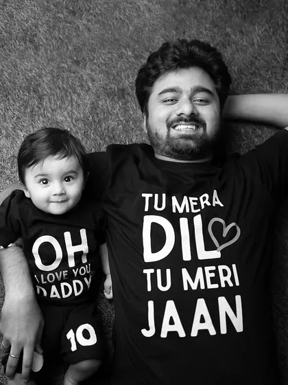 The black and white version of the father and son in matching t-shirts. This timeless edit emphasizes the expressions and the fun graphic text on their shirts.