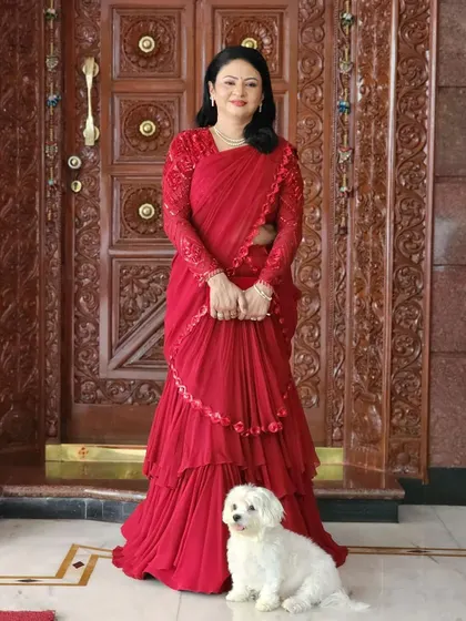 A full-length shot showcasing her stunning red ruffled saree. The makeup is the perfect finishing touch to this show-stopping look.