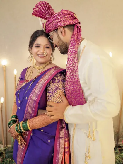 A sweet moment between the couple. The bride's soft makeup and elegant Nauvari create a timeless wedding look.