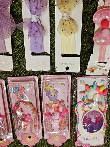 This image highlights some of my glittery and tulle hair accessories. You can see different headbands and beaded jewelry sets that are perfect for a princess or fairy themed party.