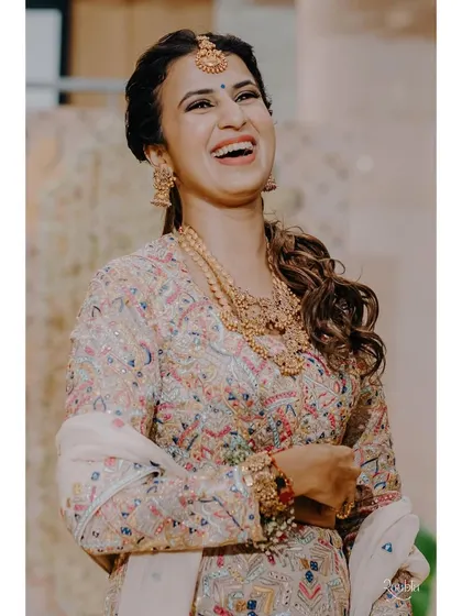 A beautiful, happy client ready for a wedding. Her makeup is soft and glowing, and she looks absolutely radiant.