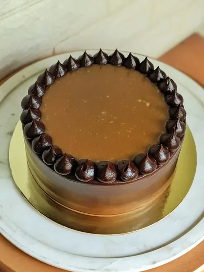 A decadent chocolate cake with a glossy salted caramel drip. It's a simple, elegant, and absolutely irresistible treat.