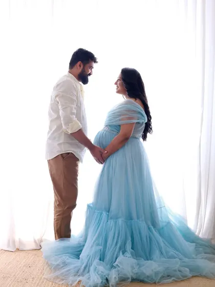 A beautiful high-key portrait of a couple, with the flowing blue gown adding a touch of fairytale elegance. This style is perfect for creating bright, airy, and romantic images.