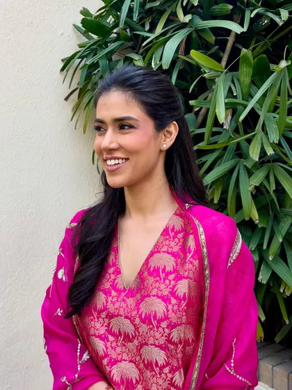 Grace in simplicity. For her first wedding event, this bride chose a soft, minimal look to go with her pink Raw Mango suit, proving that less is truly more.