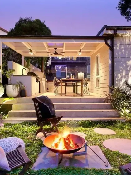 I create cozy evening retreats with features like this fire pit and covered dining area. The right lighting makes the space usable and beautiful after sunset, perfect for relaxing or entertaining.