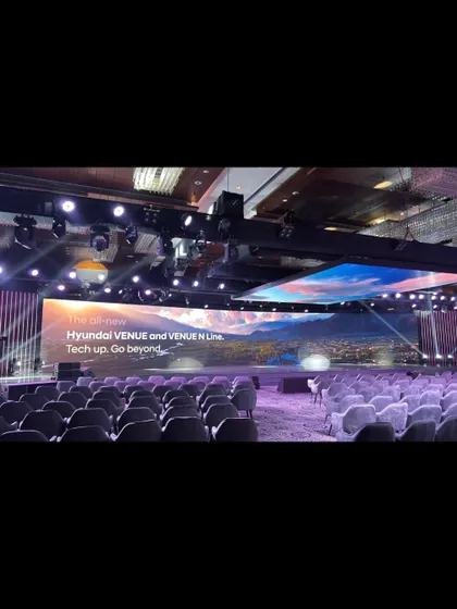 An empty conference hall before the Hyundai Venue launch, showing the scale of the event we are about to run.
