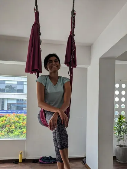 A smiling student enjoying a quiet moment in the hammock during a weekend session.