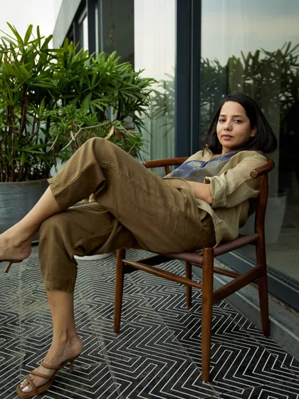 A portrait of a designer in her own space. Capturing subjects in their environment adds a layer of authenticity and tells a richer story about who they are.