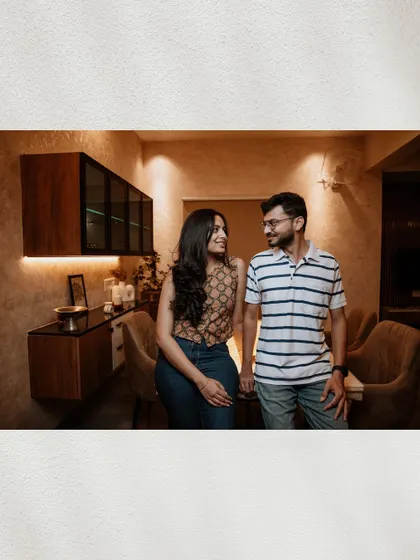 A candid shot of the couple in a modern kitchen setting, sharing a look of love and understanding.