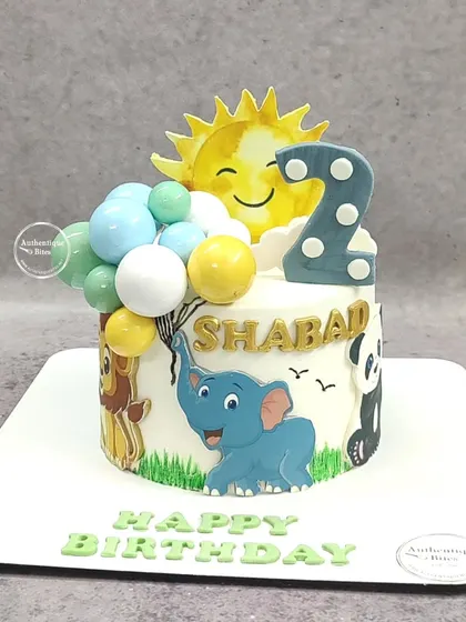 A "Love for animals" cake featuring a happy sun, an elephant holding balloons, a lion, and a panda.