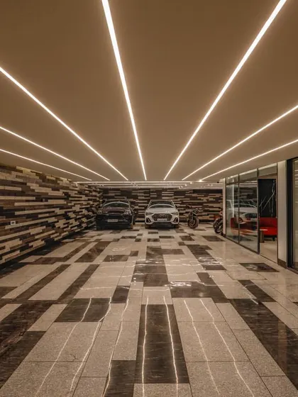 We believe luxury is in the details, and that extends to every part of a home. For this project, we designed a parking area with custom stone inlay flooring and a textured wall, transforming a utilitarian space into a design statement.