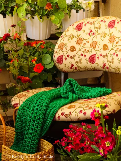 As the season changes, I love bringing out my cozy creations. This rich green crochet throw is perfect for draping over a chair in the garden, ready for a cool evening.