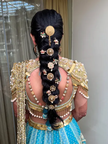 An intricate and heavily accessorized bridal braid, perfect for a traditional Haldi ceremony.