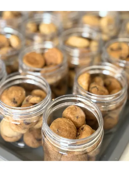 Jars of our Orange Chocolate cookie bites, ready to be packed into hampers. These mini cookies are always a crowd-pleaser.