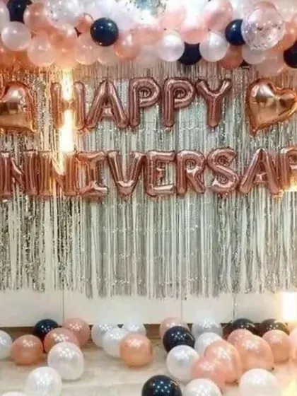 Celebrating another year together? Our anniversary decorations are all about elegance. This setup uses a trendy rose gold color scheme with a "Happy Anniversary" foil balloon banner against a shimmering silver fringe backdrop, creating a beautiful and celebratory atmosphere.