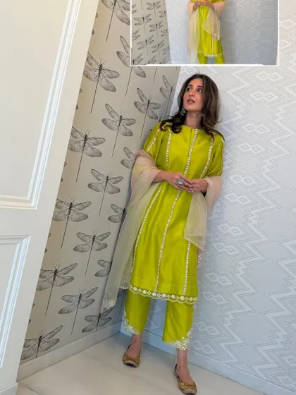 A fresh and vibrant lime green kurta set for Dhvani. This look is perfect for a daytime festive event, like a mehendi ceremony or a puja.