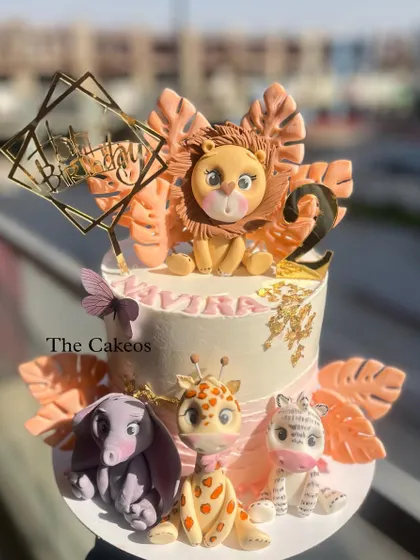 Another view of the pink and orange jungle cake, showing the adorable fondant animals from the front.