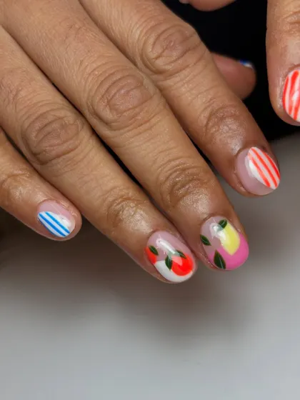 This shot from the fruity set features hand-painted lemons and apples, along with colorful striped accent nails.