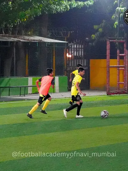 A player dribbles down the line while being pursued by a defender in a bib. This simulates a real-game scenario on the wing.