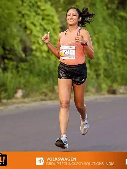 A crazy mind doesn't quit. Giving a thumbs-up during the Pune Hill Half Marathon, embracing the challenge and the burn.