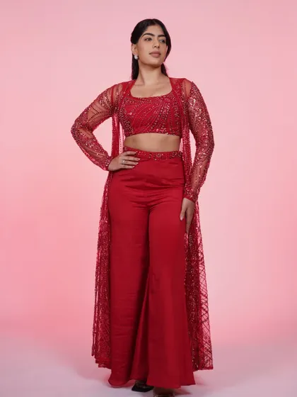 This red three-piece set with a sequined crop top, pants, and a sheer jacket is a total power move. It's bold, chic, and perfect for a cocktail party or reception.
