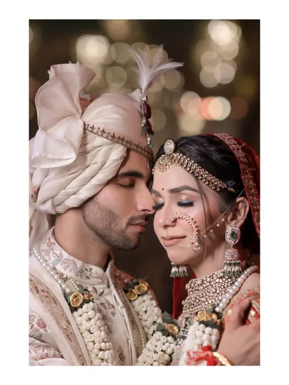 An intimate close-up of the bride and groom during their wedding ceremony, with beautiful bokeh in the background.