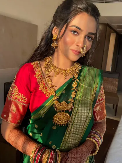 A portrait of the bride, showing how the long, flowing curls beautifully frame her face and complement her traditional jewelry.