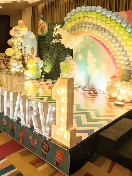 A side view of the Cocomelon stage, highlighting the large rainbow balloon arch.
