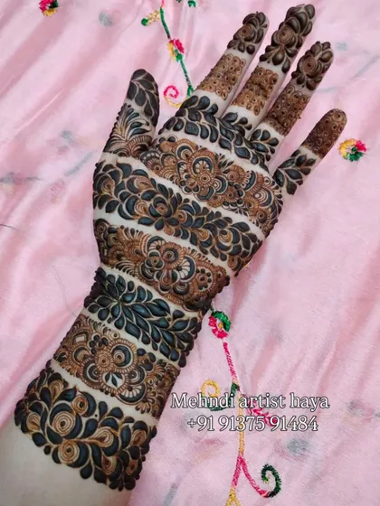This unique design features horizontal bands of intricate patterns, a modern take on traditional Indian motifs. The use of negative space makes each band stand out.