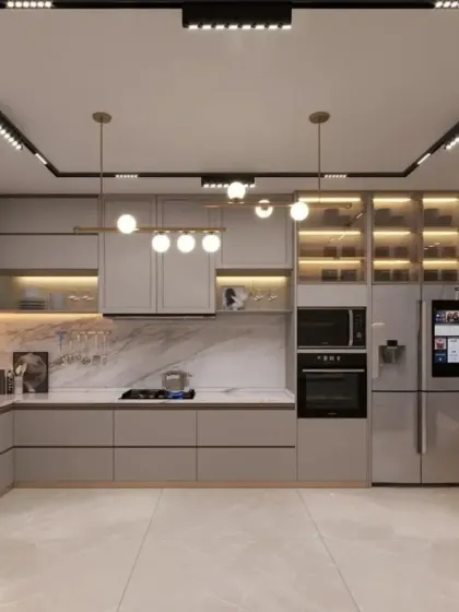 A modern modular kitchen designed for both style and serious cooking. This layout includes handleless cabinets, integrated appliances, and a smart refrigerator, all tied together with multi-level lighting from track lights to under-cabinet LEDs.