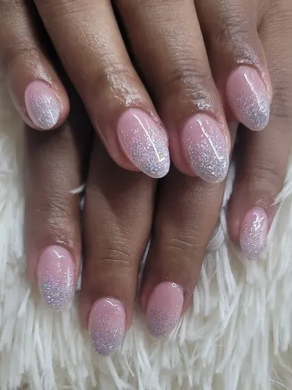 A classic glitter ombre on a sheer pink base, with sparkling silver glitter concentrated at the tips.