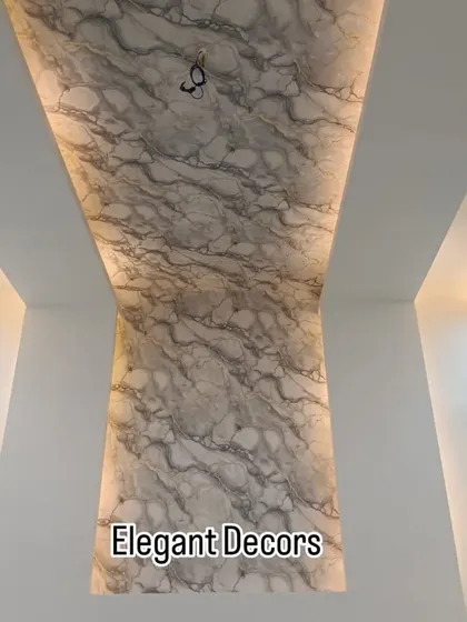 Here, I've used a single, continuous UV marble sheet that flows from the wall up to the ceiling, creating a dramatic and seamless effect. The side cove lighting highlights the beautiful marble texture, making the entire space feel taller and more luxurious.