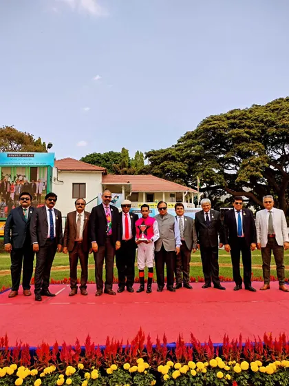 The presentation ceremony for The Champion Trainer Trophy with the winning team of Armstrong.