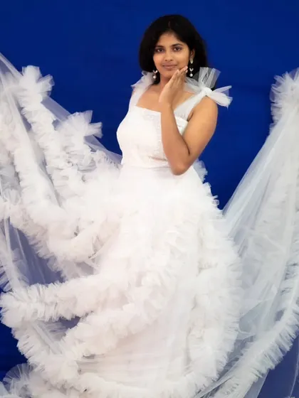 A full view of the white ruffle gown with its dramatic detachable sleeves.