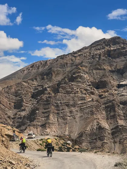 This is what it's all about. Two riders on the iconic Manali to Leh cycling expedition, dwarfed by the immense beauty of the Ladakh landscape. We believe in raw, real adventures, and this is one of our biggest.