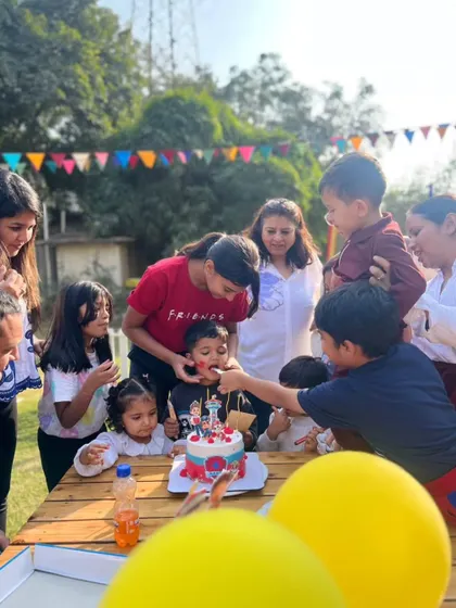 The joy of sharing cake with friends. This picture captures the fun and community spirit of a birthday party at our farm.