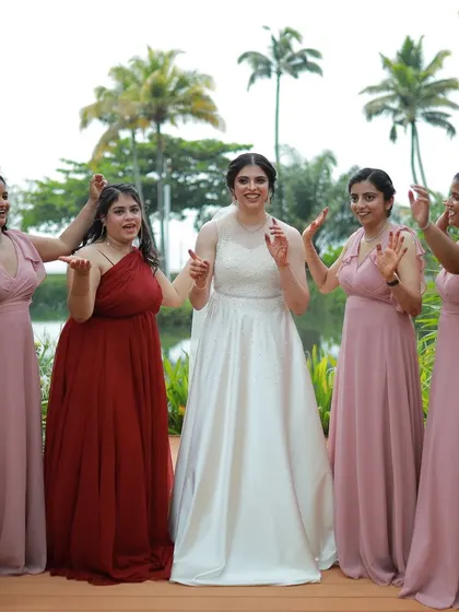 The bride and her bridesmaids sharing a laugh. Capturing the fun and support of the bridal party is a key part of the wedding story.