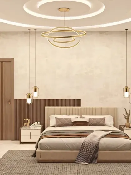 This spacious and airy bedroom design features a beautiful false ceiling with layered lighting and elegant pendant lamps. The neutral color palette and clean lines create a calm and contemporary atmosphere.