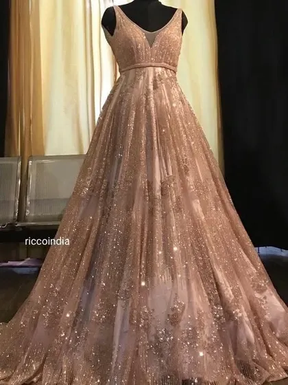 This rose gold sequin gown is designed to catch the light from every angle. It's a perfect choice for a sangeet or reception, ensuring you are the star of the evening.